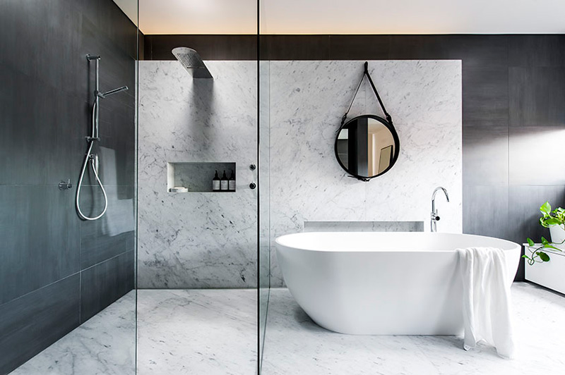 Modern bathroom with marble walls and shower niche