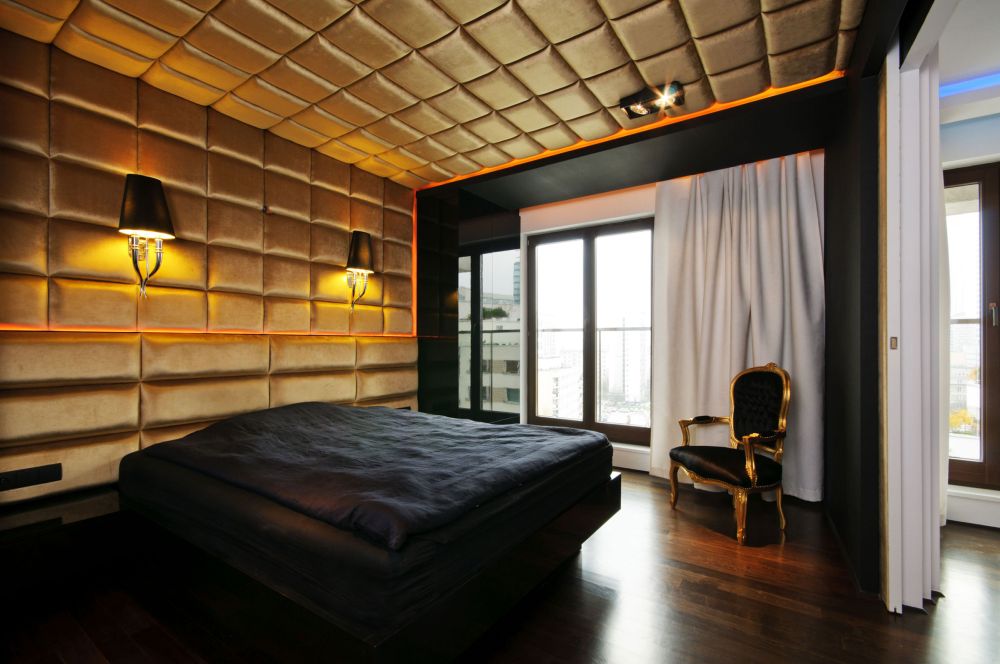 Modern bedroom in black and gold featuring a tufted ceiling in gold