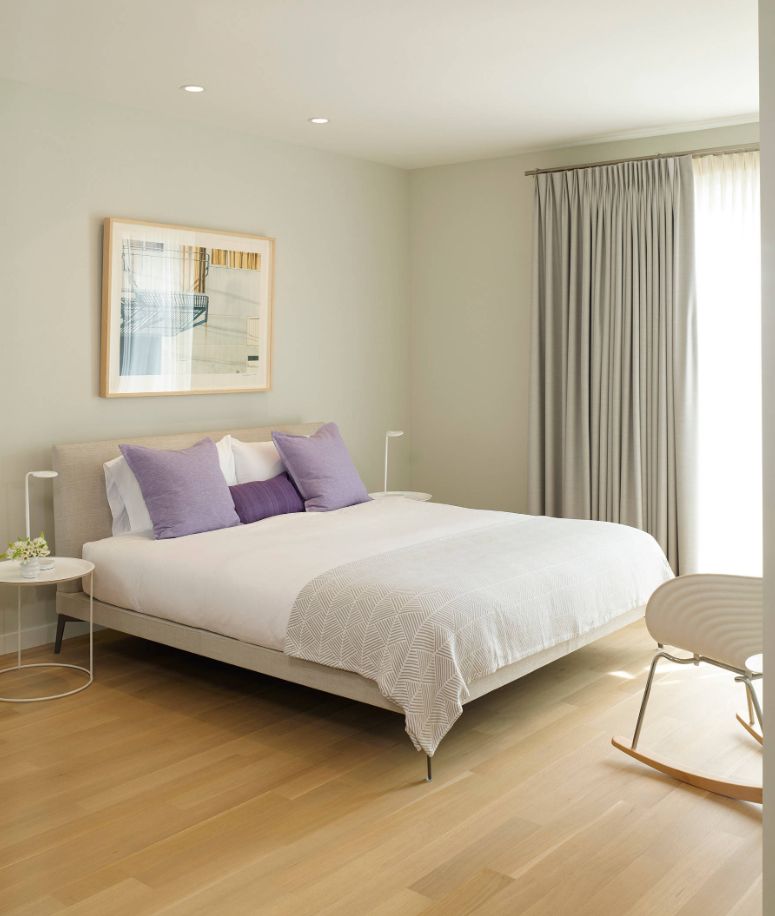 Modern bedroom with purple accent pillows