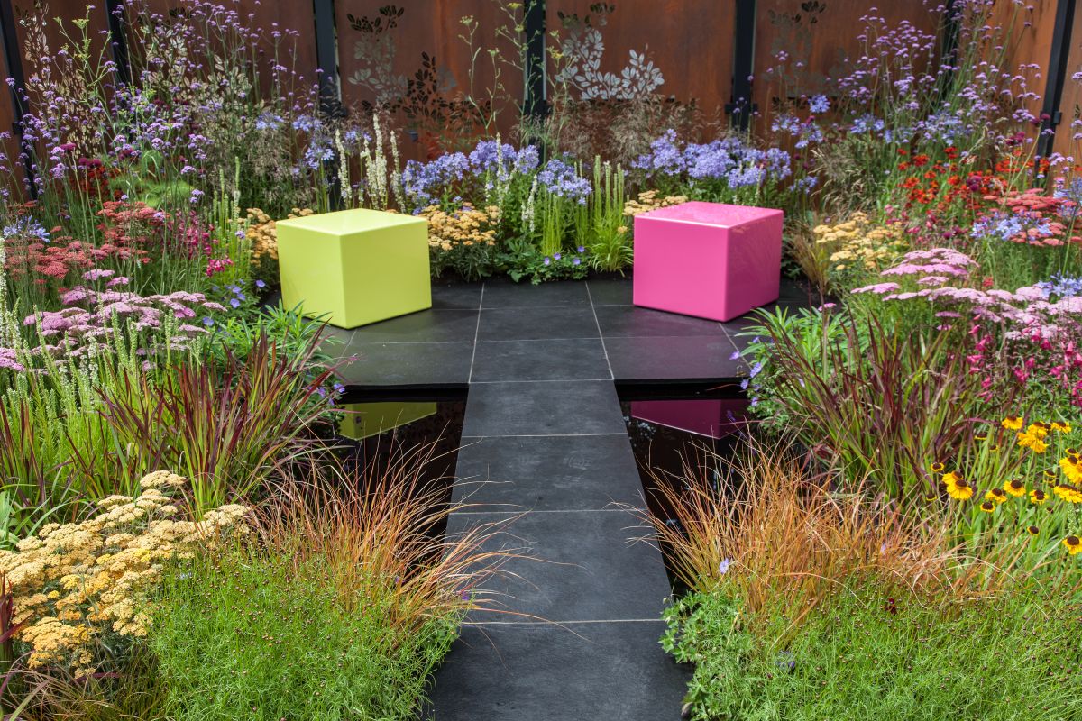 A water feature such as a small pond can be quite relaxing to look at and a bench can really help with that