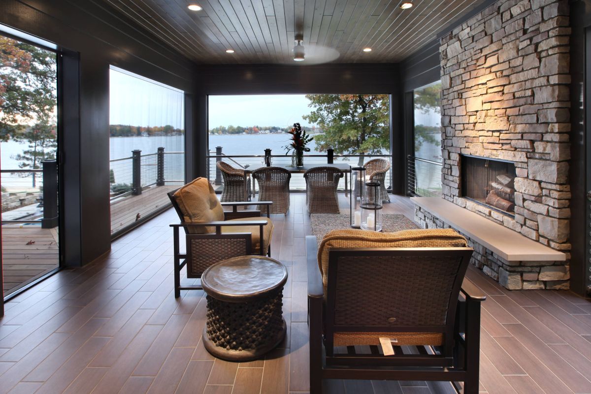 Modern screened porch with stone stacked fireplace