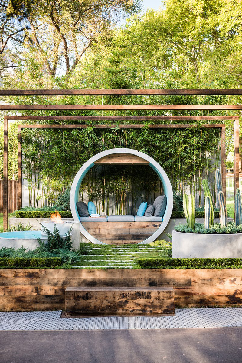 Modern urban garden featuring concrete pipes for seating