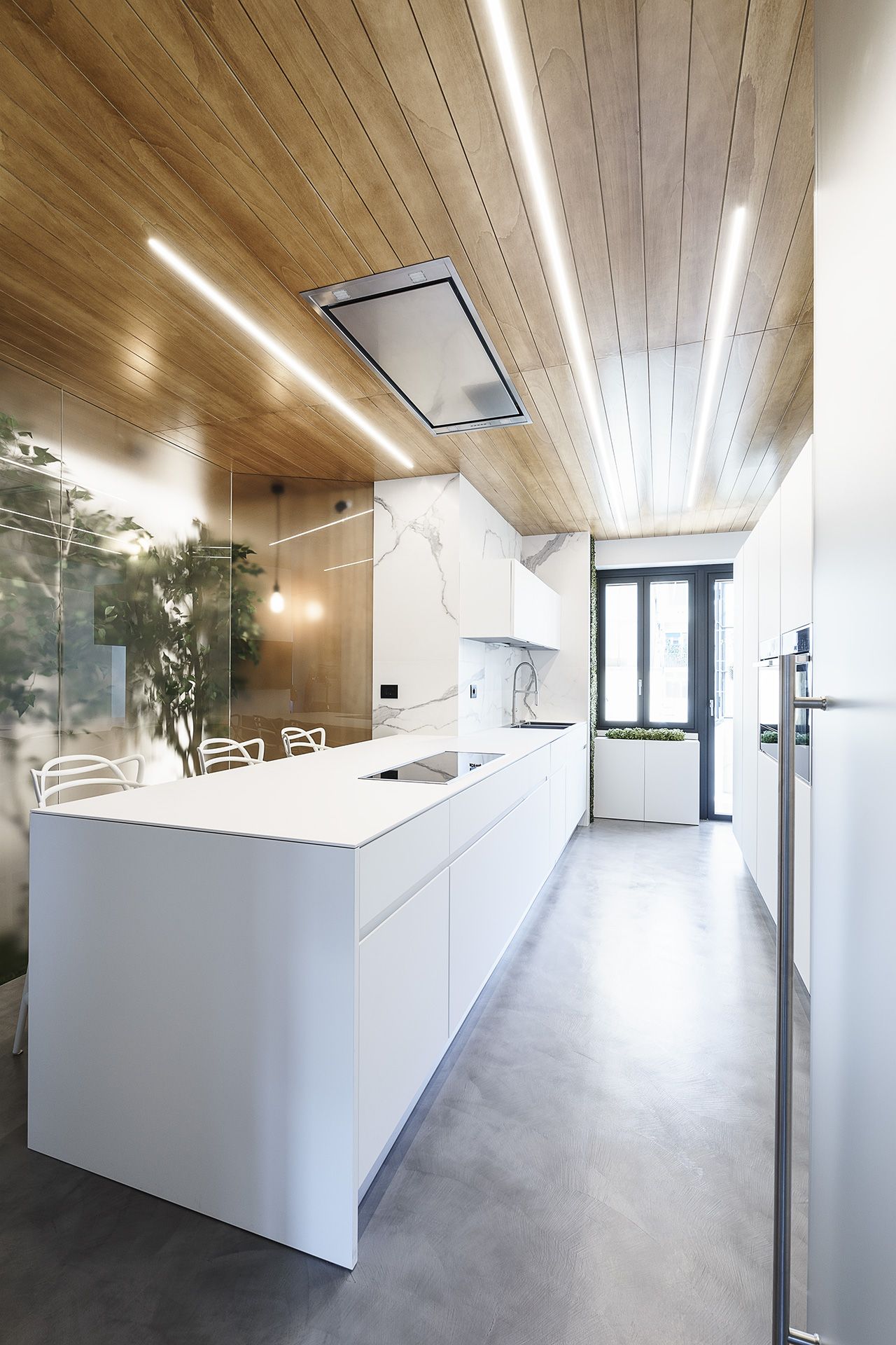 The sleek kitchen is modern and monochrome.