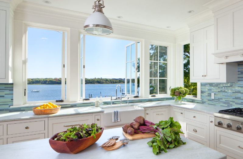 Modern white kitchen with large view to lake