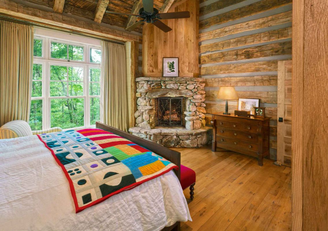 Mountain cabin bedroom with stone fireplace for corner