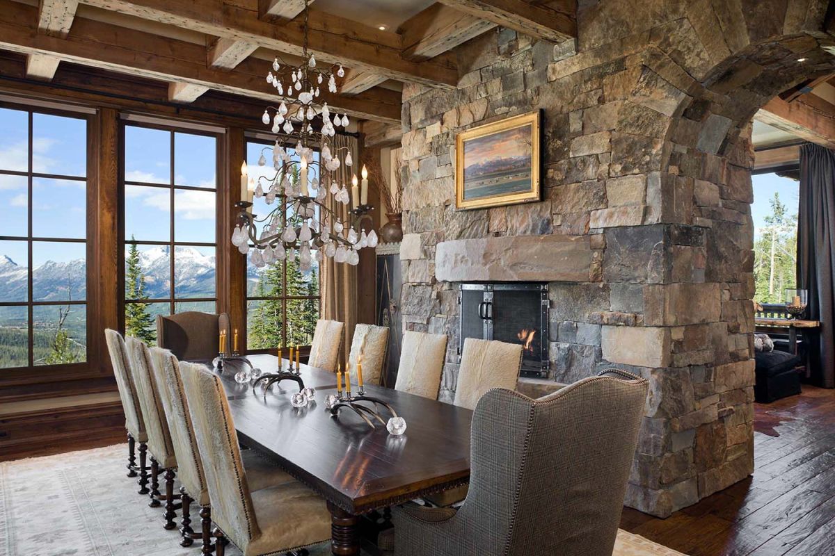 Mountain rusting dining room with fireplace wall divider from stone