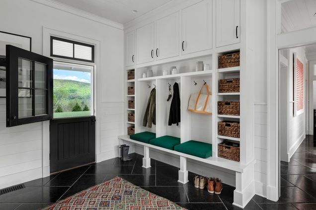 Mudroom with black floor tiles