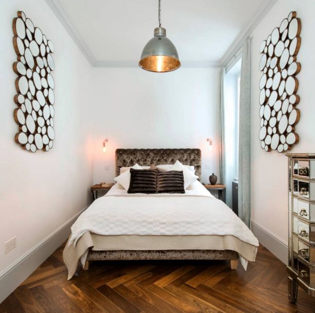 Narrow bedroom featuring wooden wall art pieces