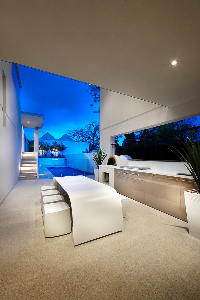 White outdoor kitchen with a minimalist design