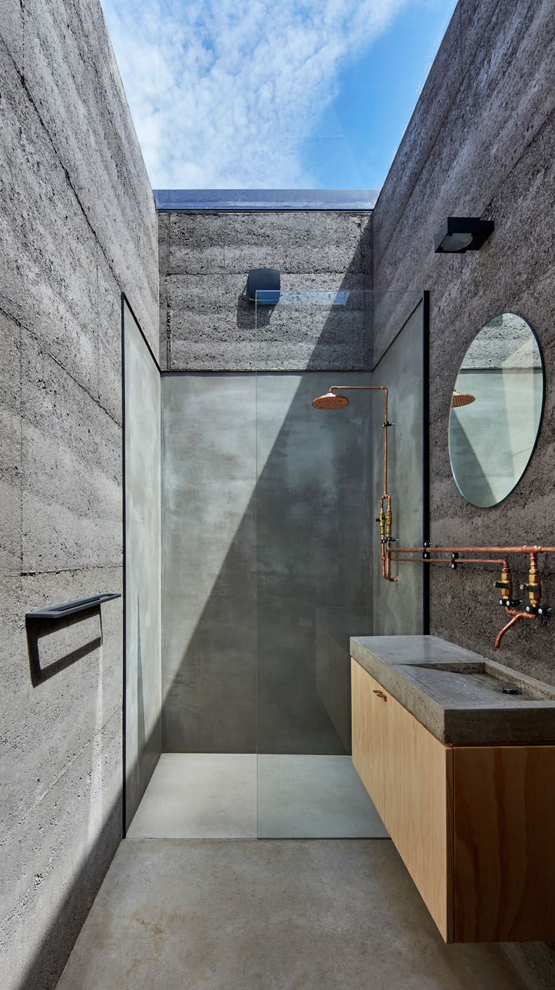 Narrow outdoor shower design concrete walls and copper plumbing