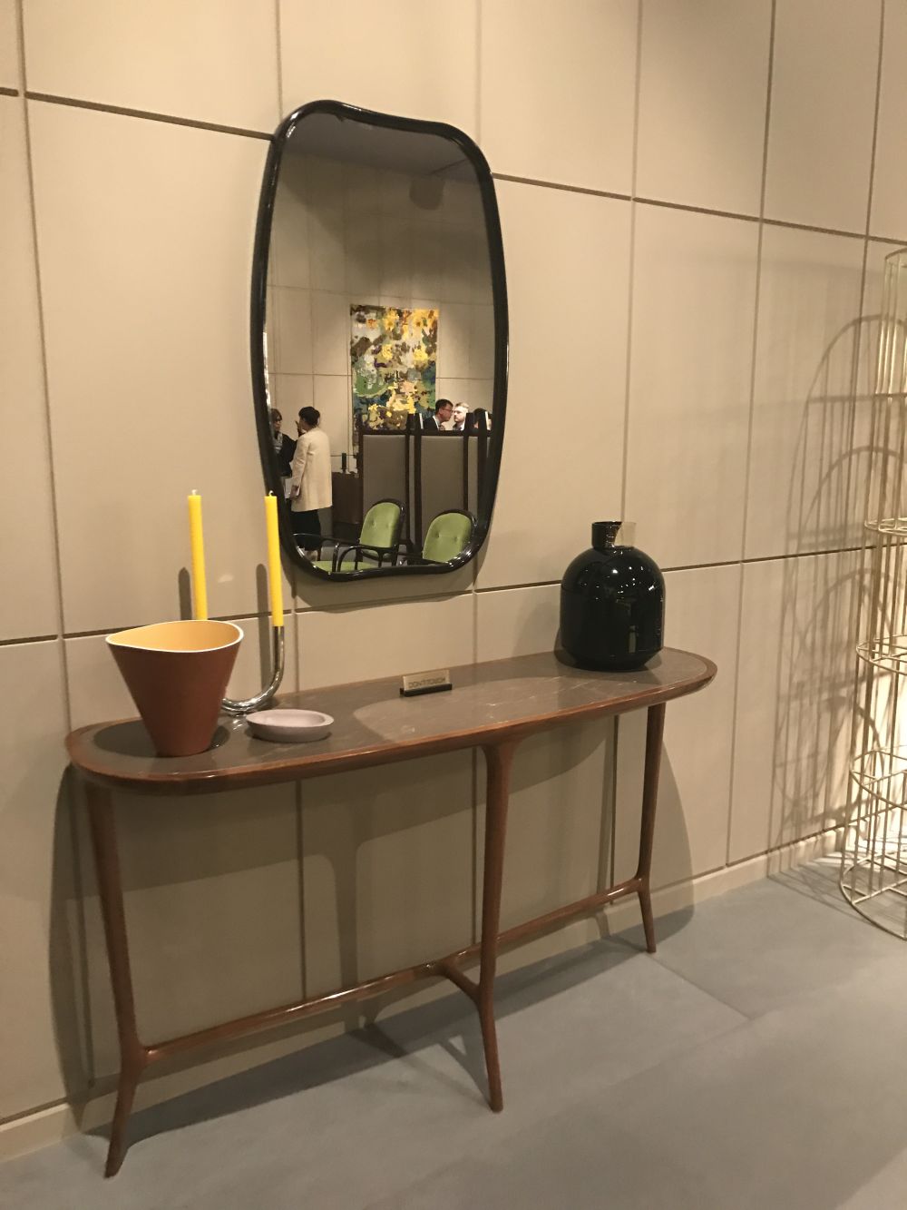 Narrow table for entryway with an oval mirror on the wall