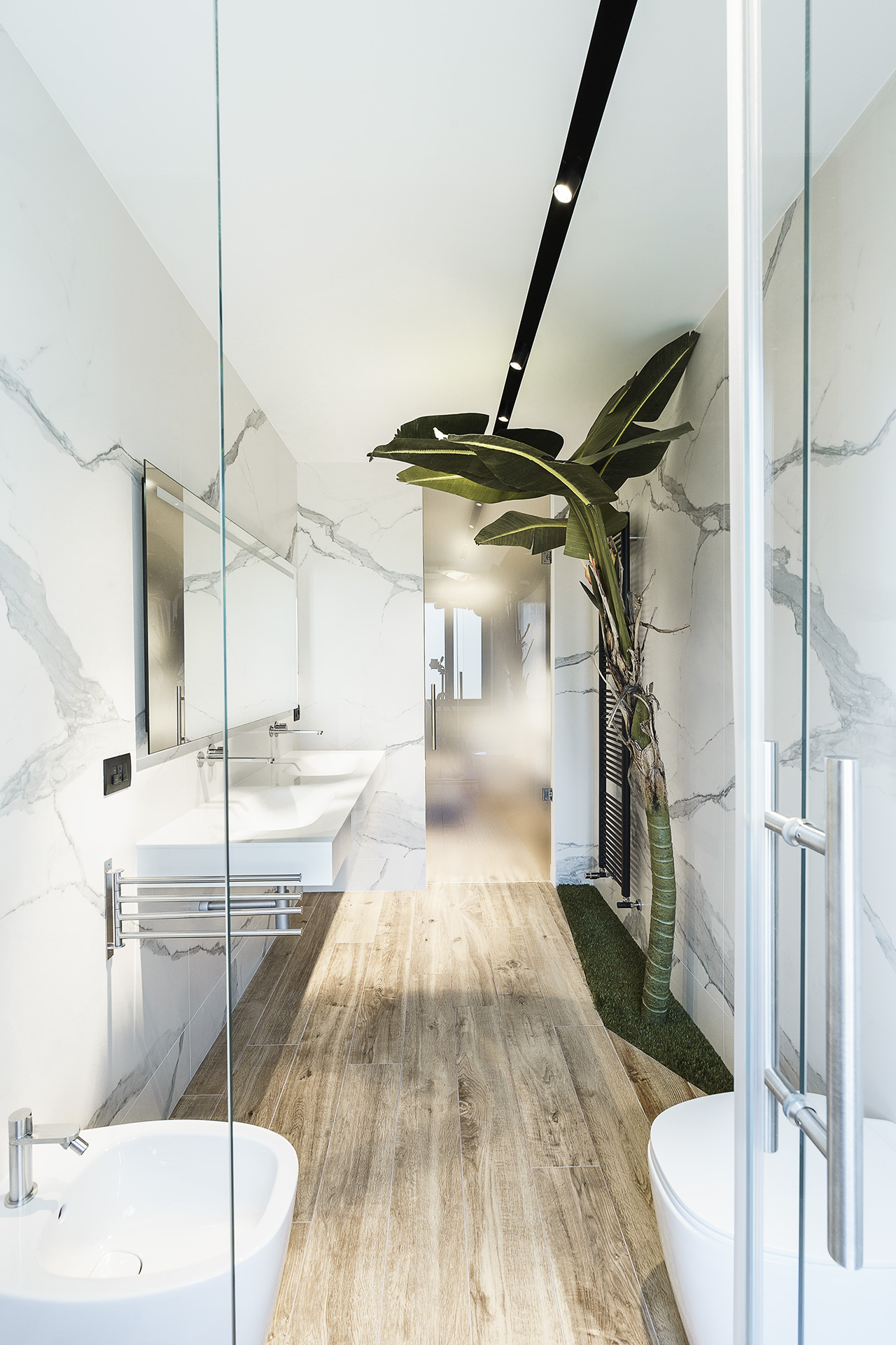 Narrow white marble bathroom