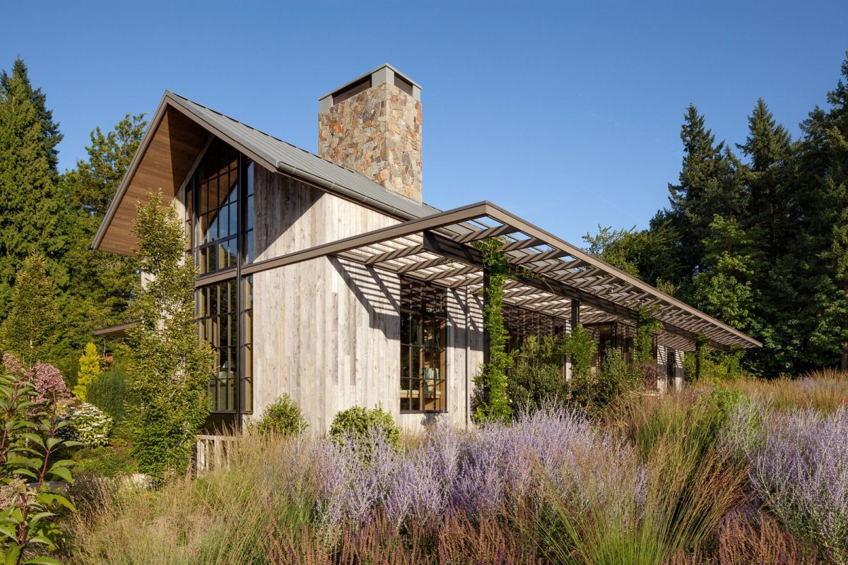 Expertly designed gardens enhance the house.