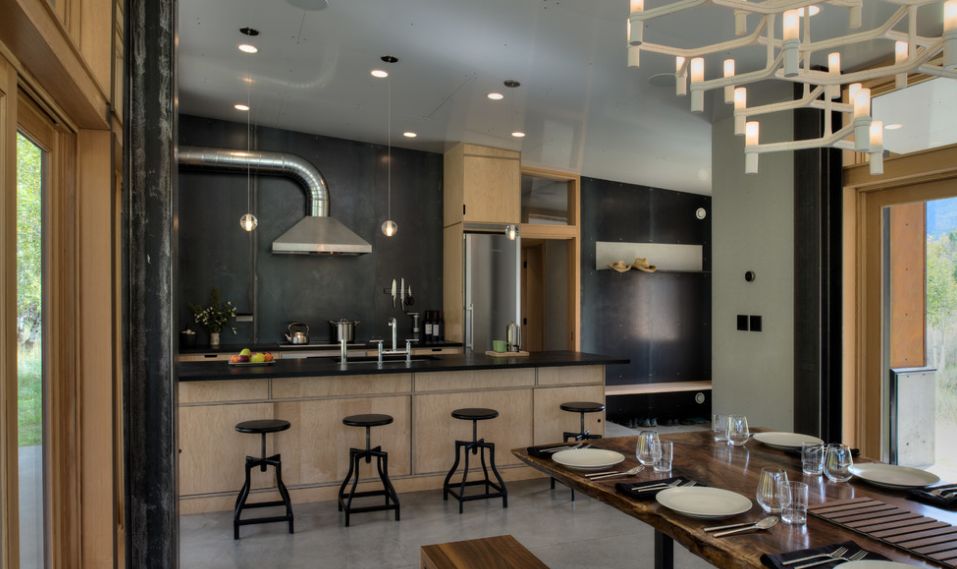 Open floor plan kitchen with black stools