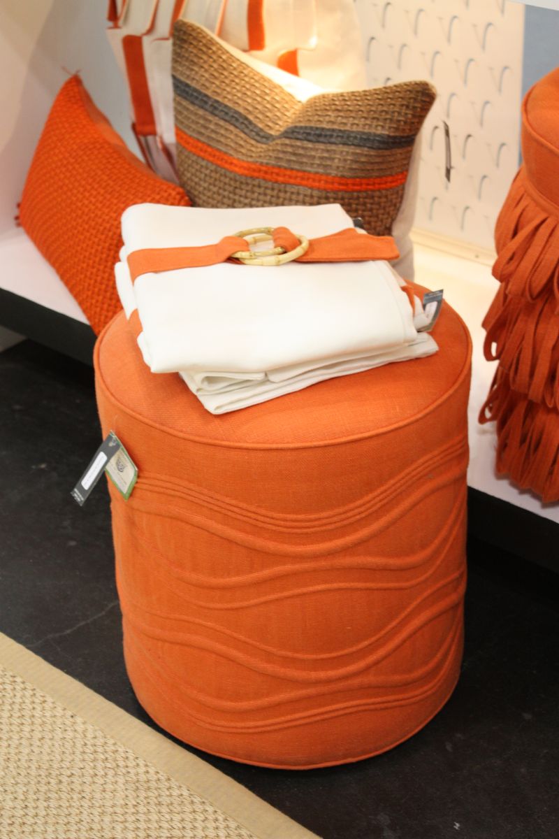 Orange ottoman for a bold living room