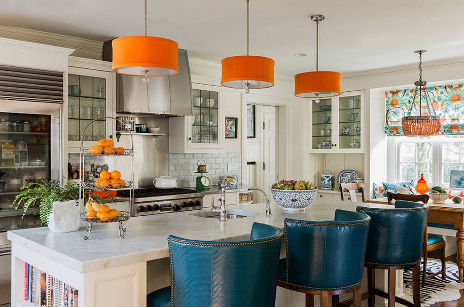 Orange pendant lamps over the kitchen island