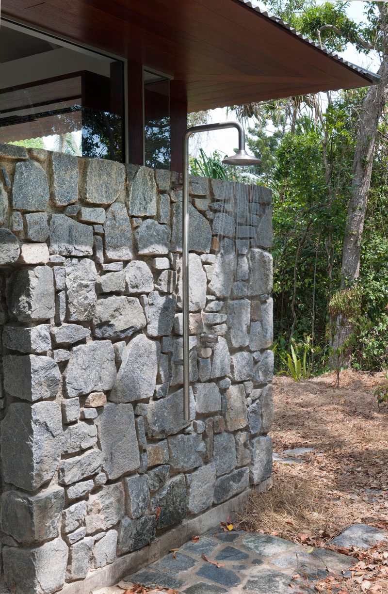 Outdoor shower on a stone wall