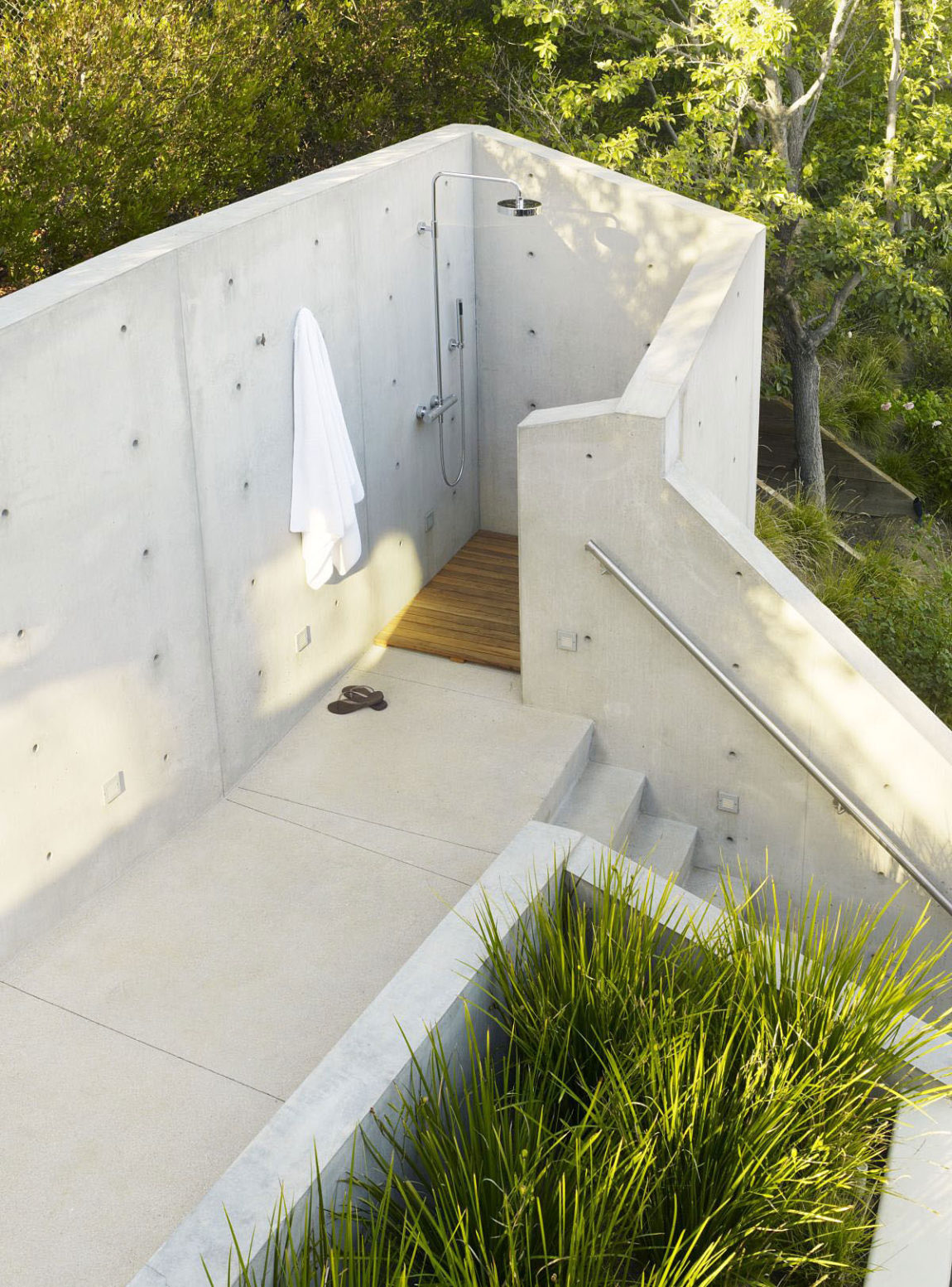 Outdoor shower with concrete wall staircase