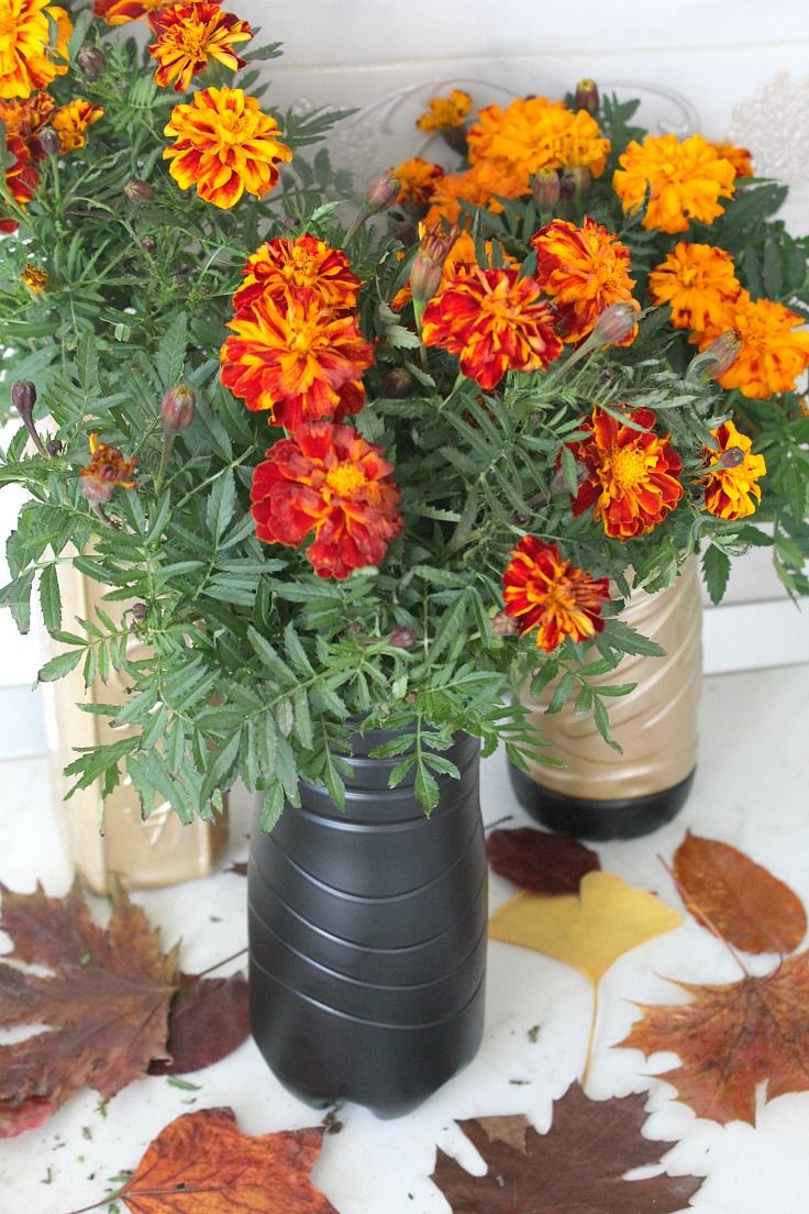 Paint plastic bottles and turn into flower vases