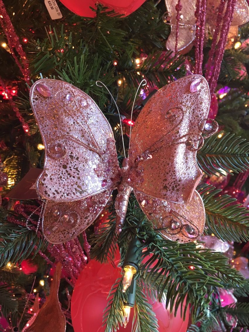 Pink bejeweled butterflies add another feminine element to the tree.