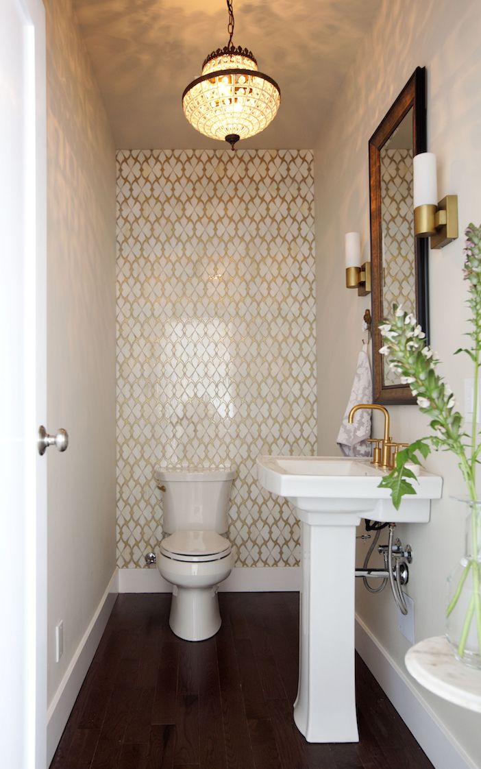 Powder room with a small design and gold accents