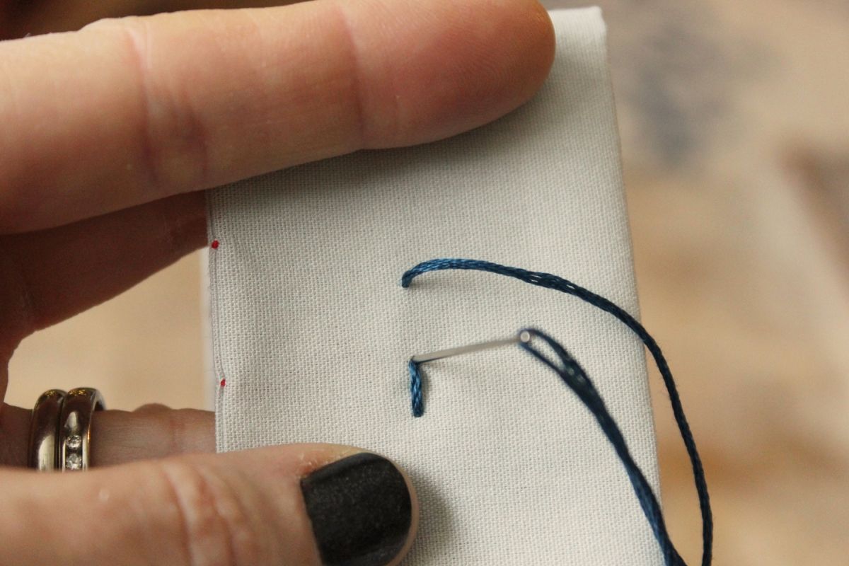 Press the tip of your needle onto the top