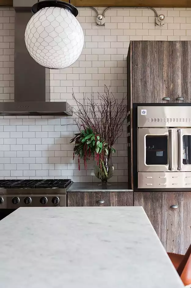 Reclaimed wood kitchen cabinets and subway tiles for backsplash