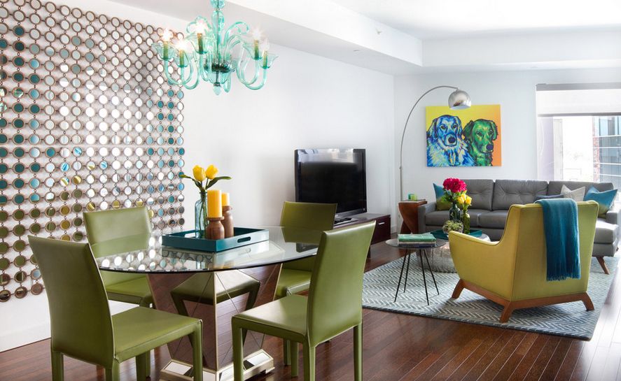 Residence with green leather furniture and round glass dining table