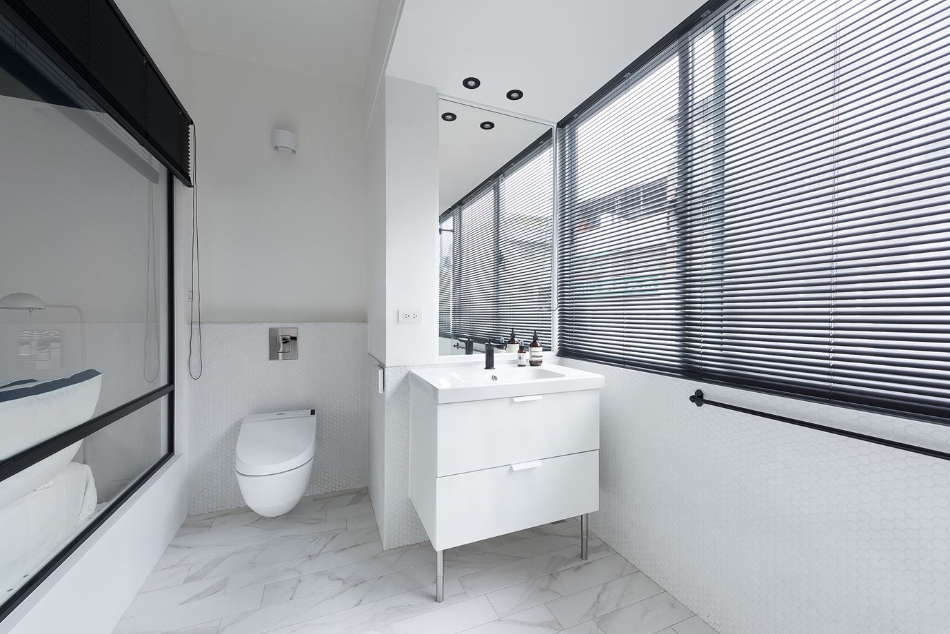 Residence with white bathroom featuring black frames