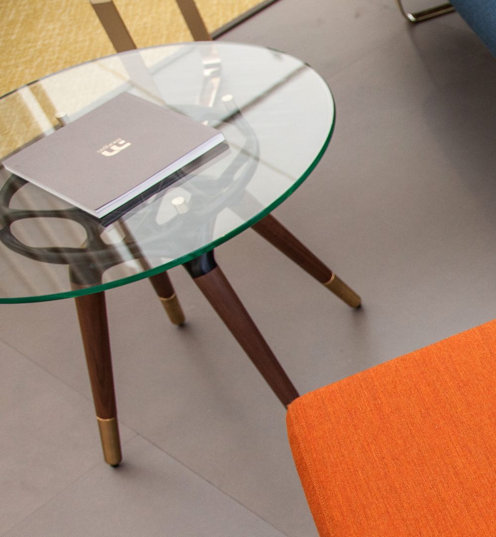 This is the Rio table, an elegant and versatile piece of furniture with a stylish glass top and metal-tipped legs