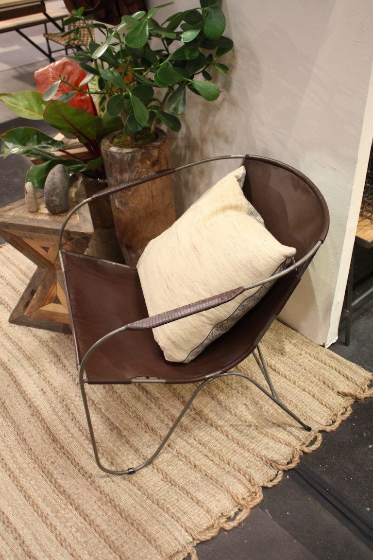 A rustic chair that features leather works well in many spaces.