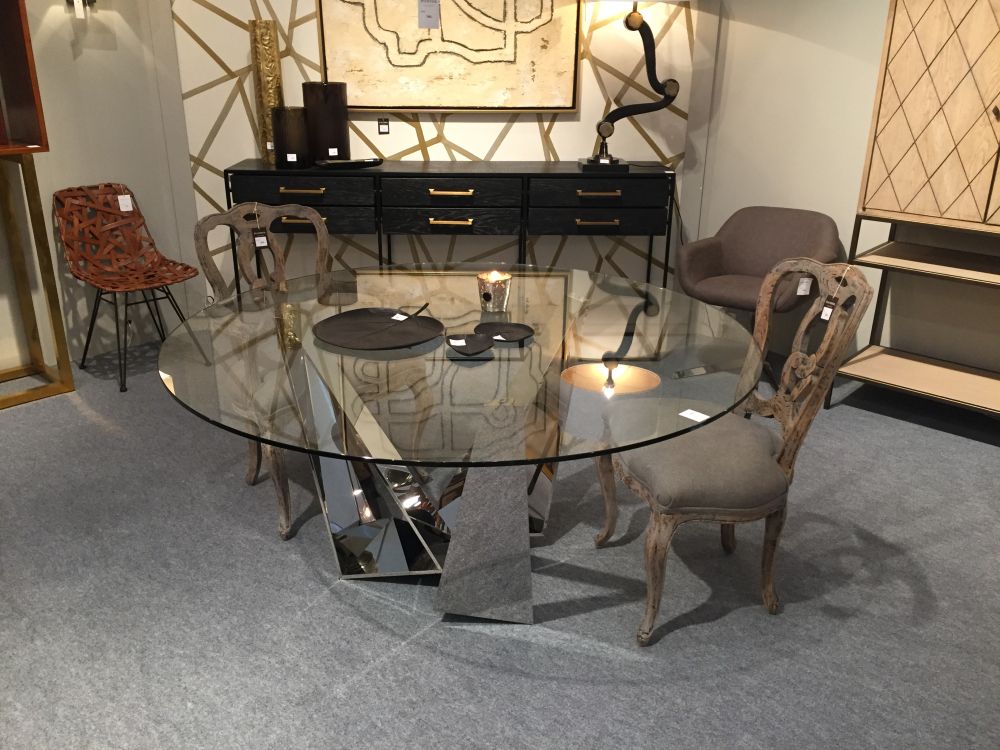 Round glass top dining table with a chromed contemporary base