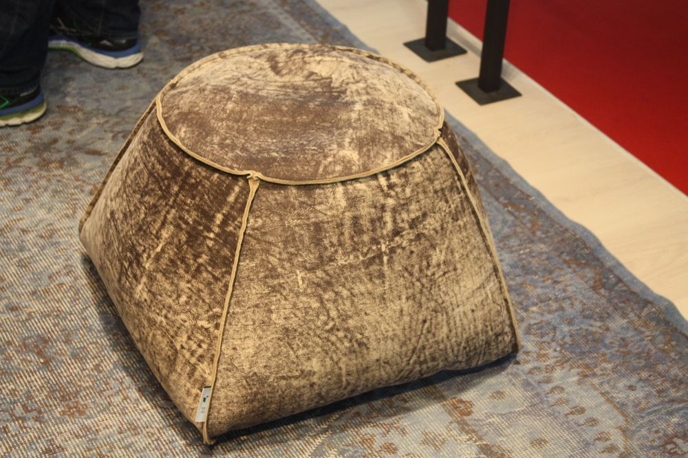 Round ottoman on top and geometrical base