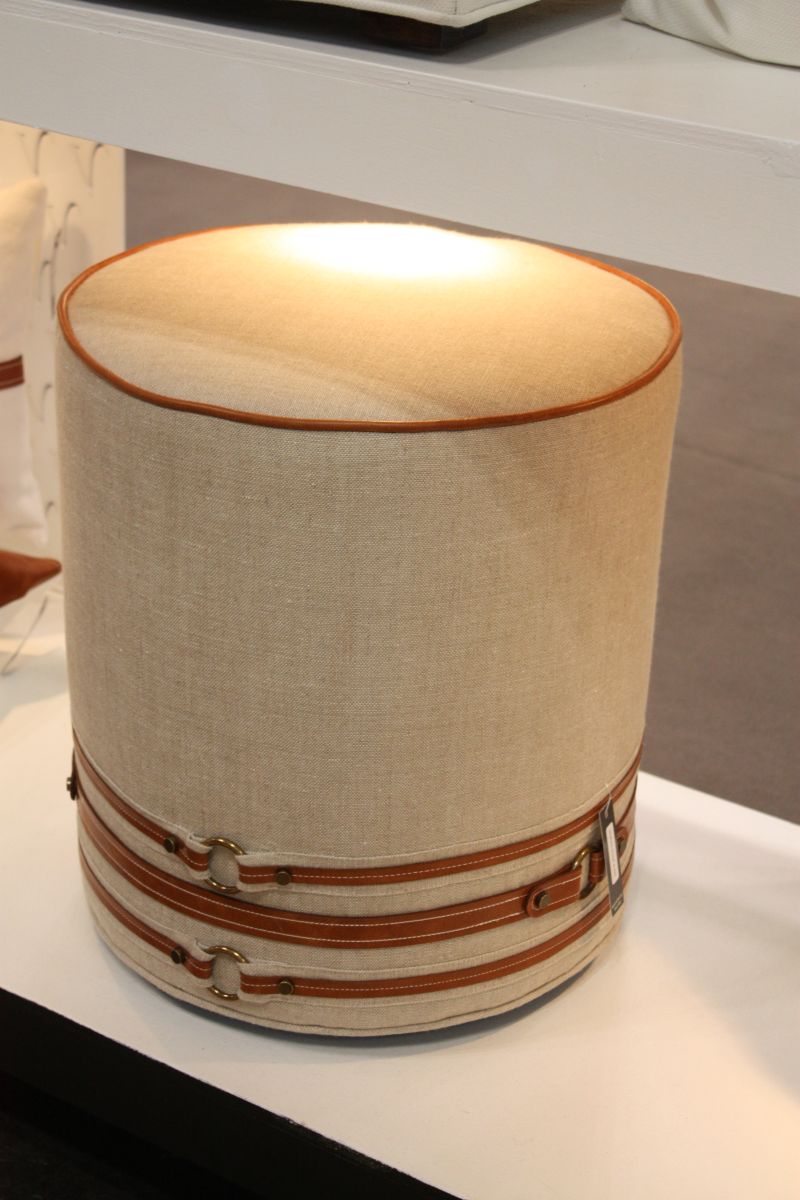 Round ottoman with leather straps