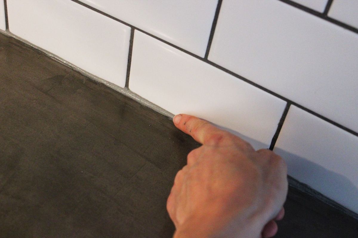 Run your moistened finger along the caulk