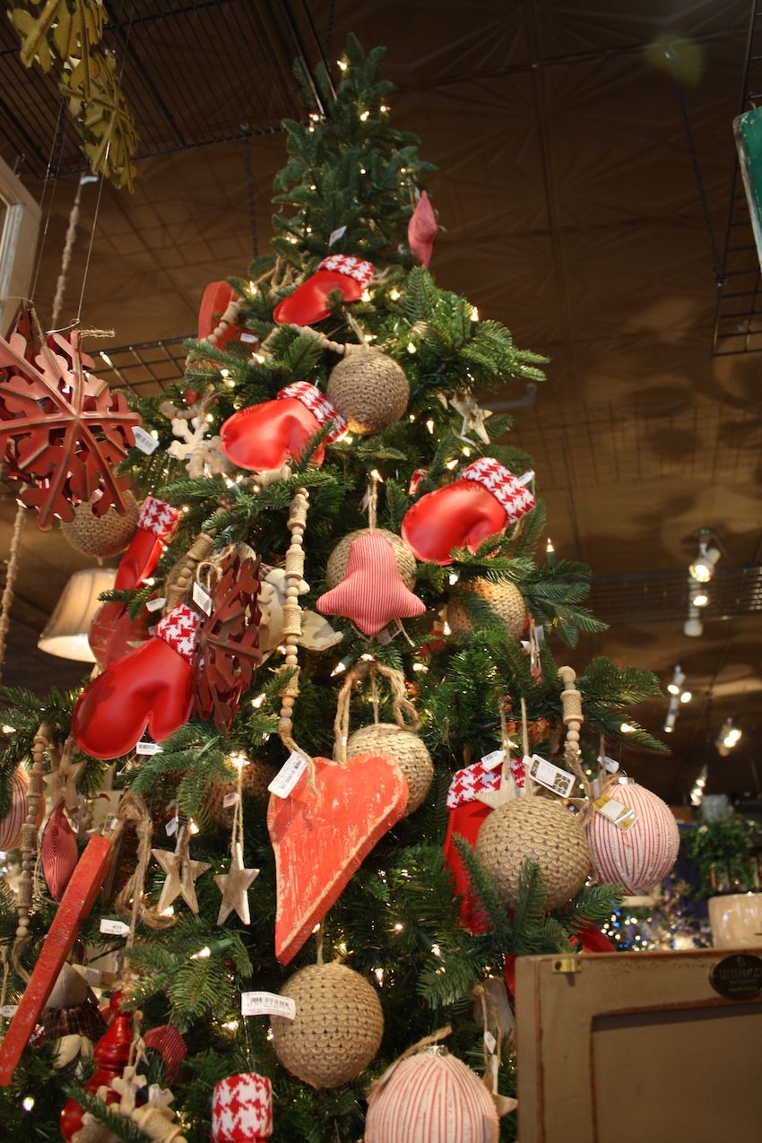 Red rustic snowflakes and a rough-hewn heart shape add unexpected elements to the tree.