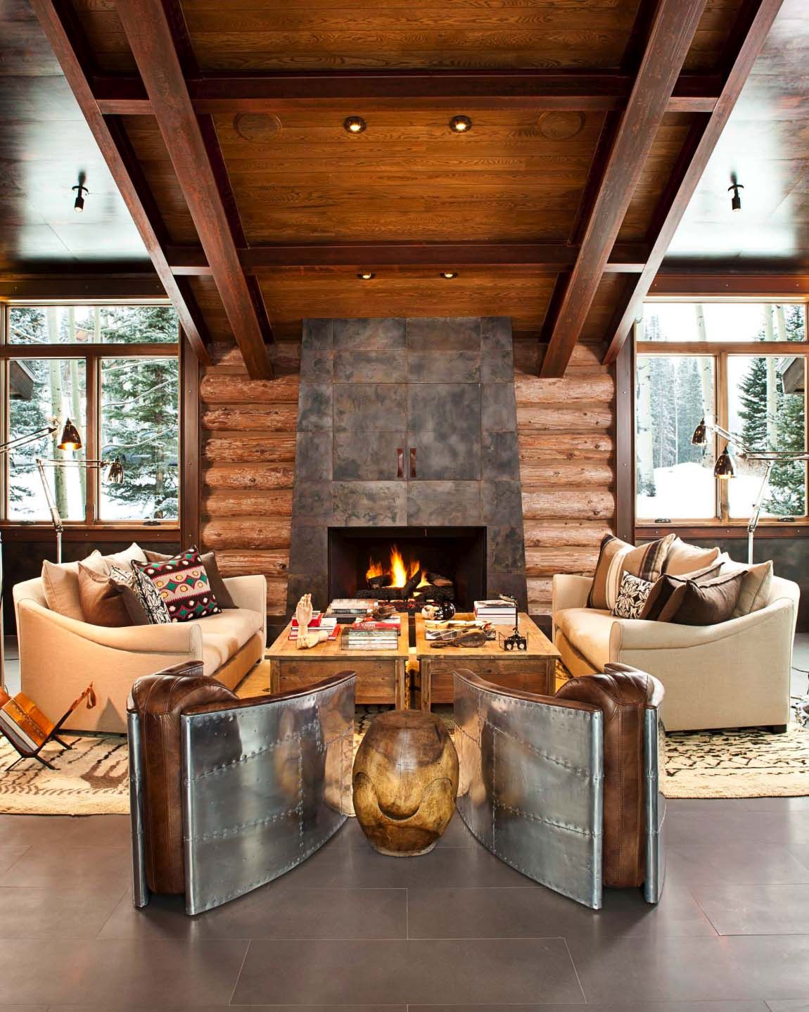 Rustic log cabin fireplace and armchairs seating