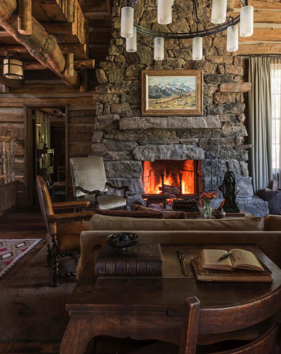 Rustic mountain home with a beautiful traditional living featuring large stone fireplace