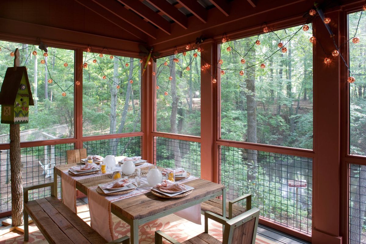 Rustic screened porch decorated with string lights