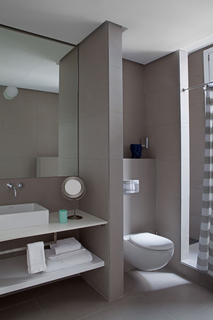 The bathroom is soothing and minimalist.