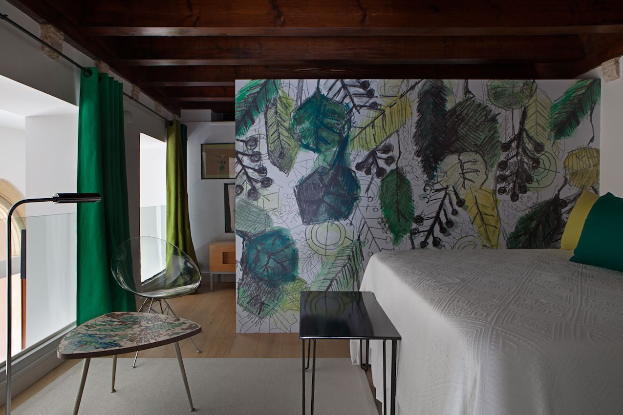 The mural is a creative and artful way to divide the room.