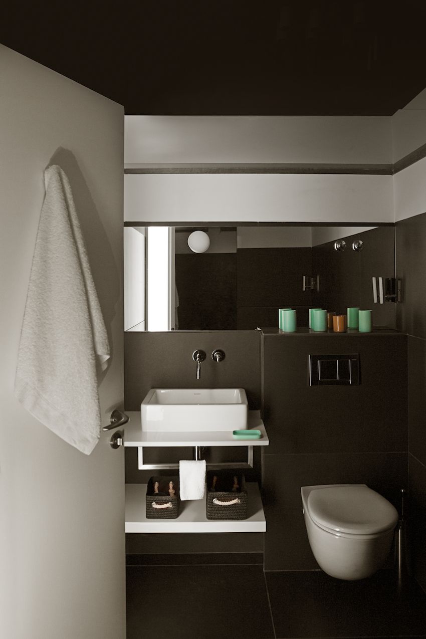 Another bathroom has a darker brown palette.