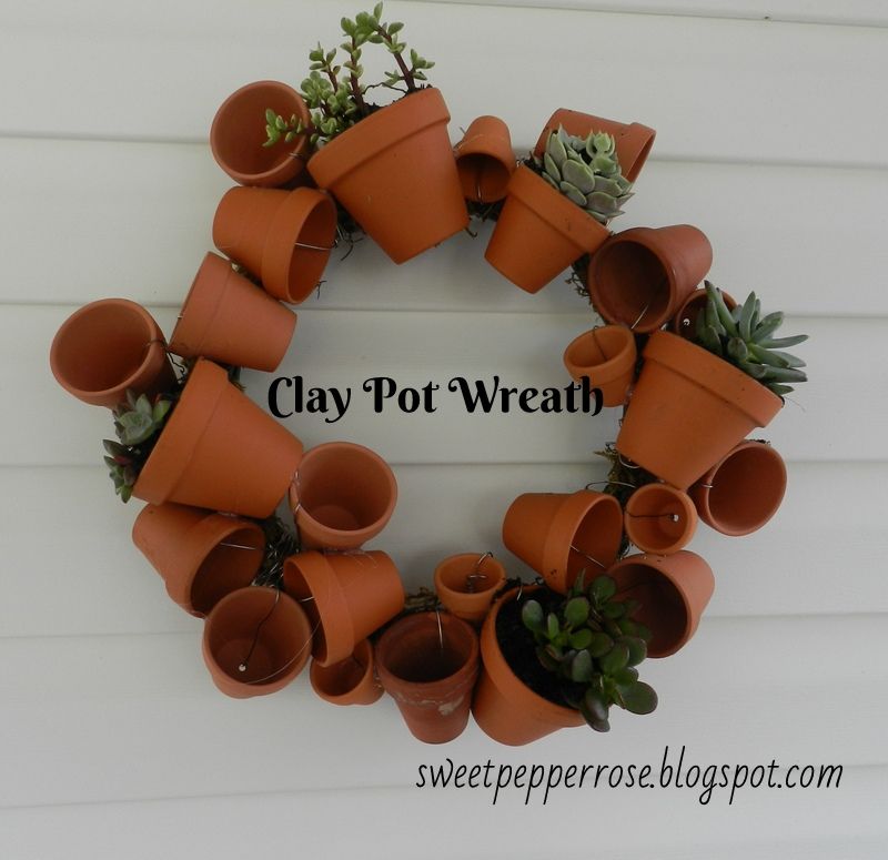 Several tiny terracotta pots into wreath