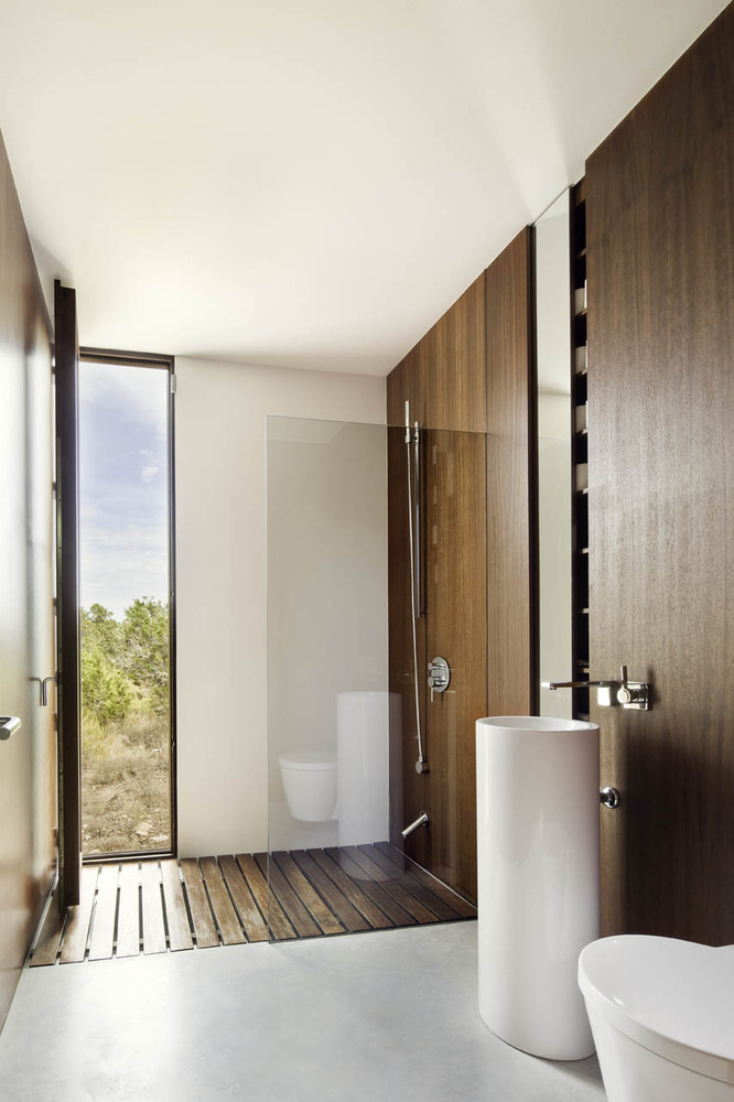 Shower with a narrow window and a wooden floor