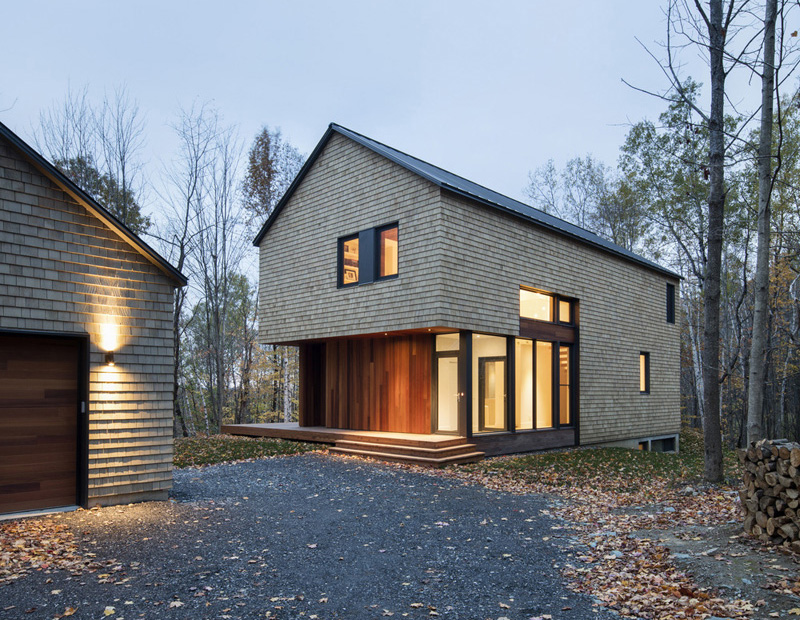 Simple forest house with cedar siding garage