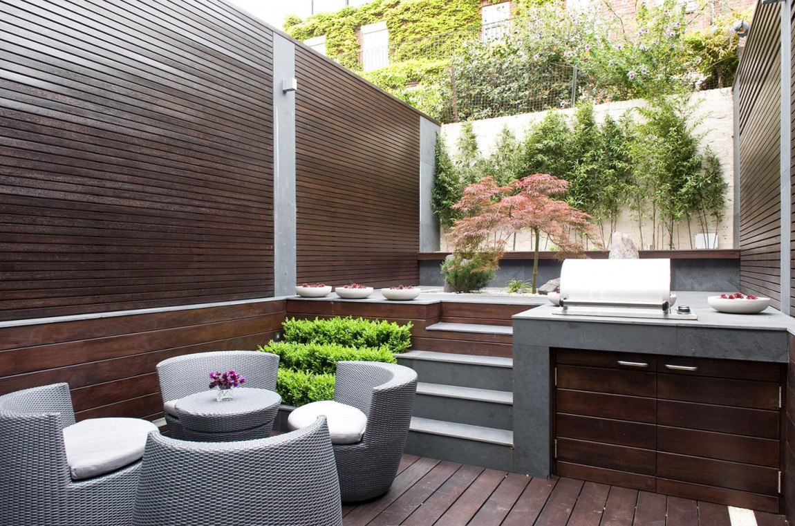 Small backyard with a kitchen and seating area