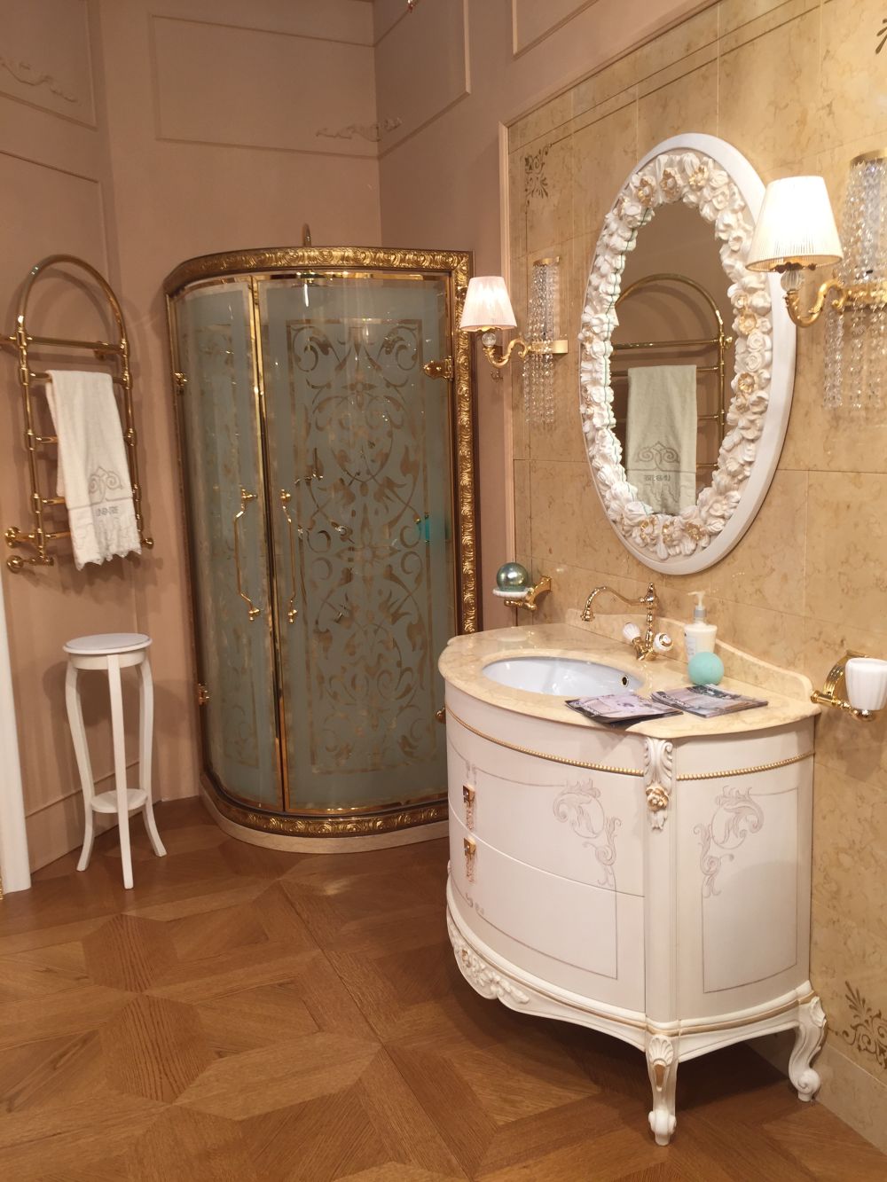 Small bathroom with gold accents and framed shower with gold accents