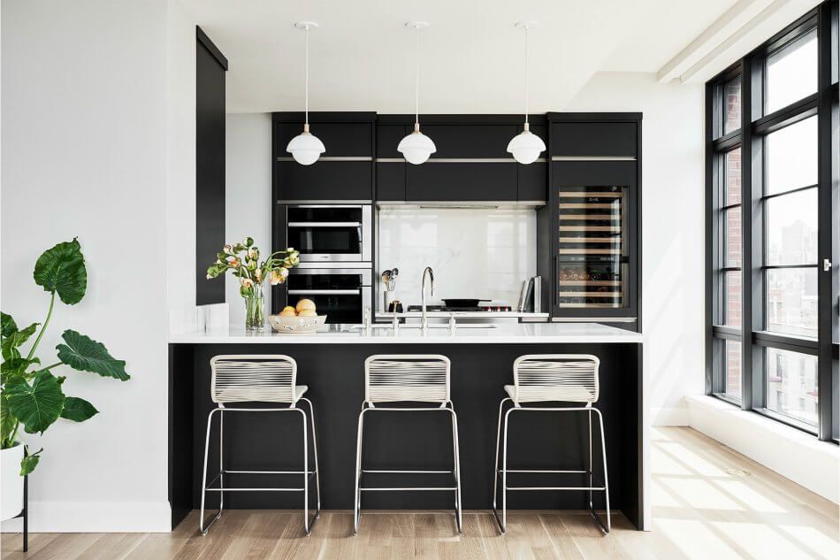 Small black kitchen with built in appliances