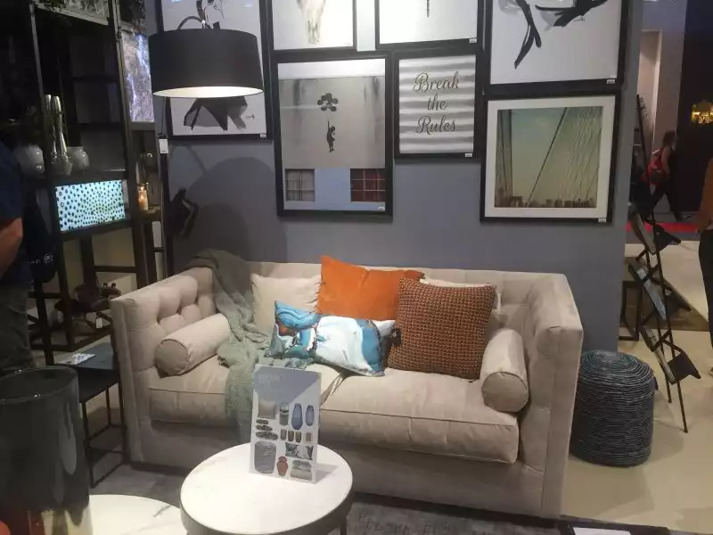 Small grey couch for a living with wall art frames