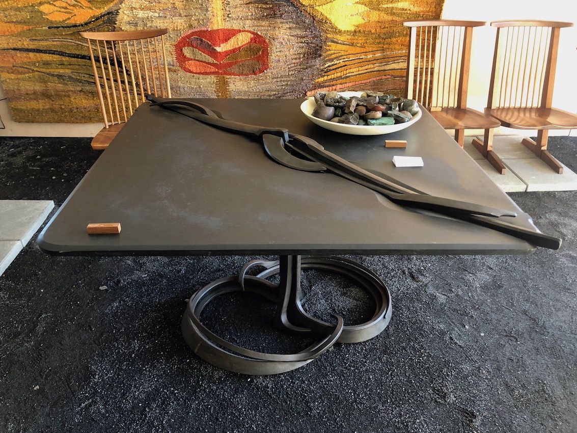 Stone and steel make a hefty table that will be the focal point of a space.